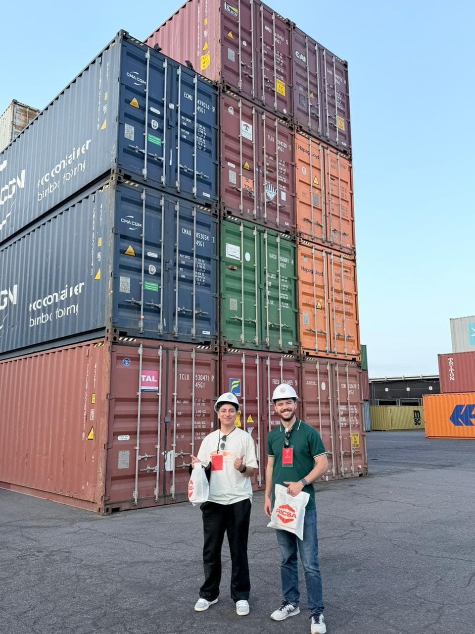 The Lumintik team among stacks of containers at the port